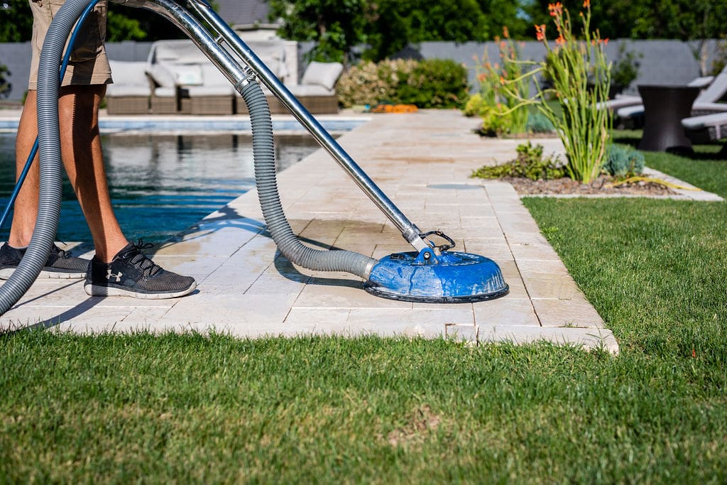 Cleaning paver in the backyard of a phoenix home
